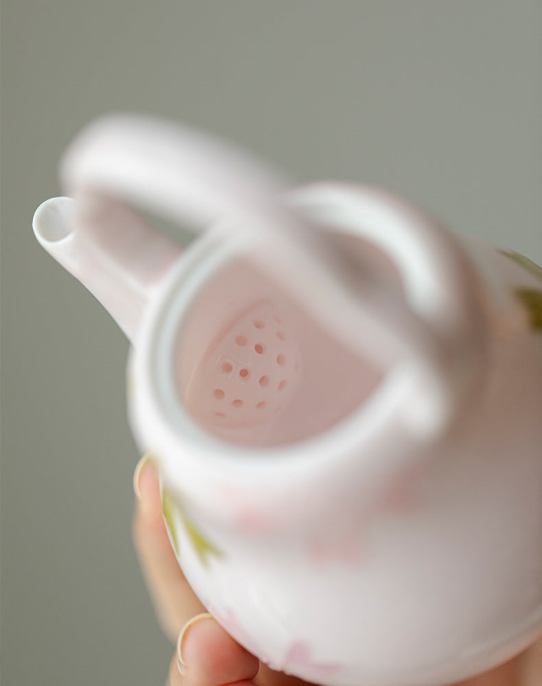 this is a pink ceramic teapot