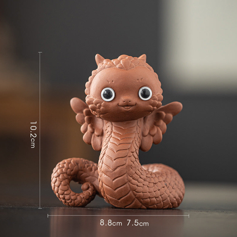 this is a white ceramic snake tea pet