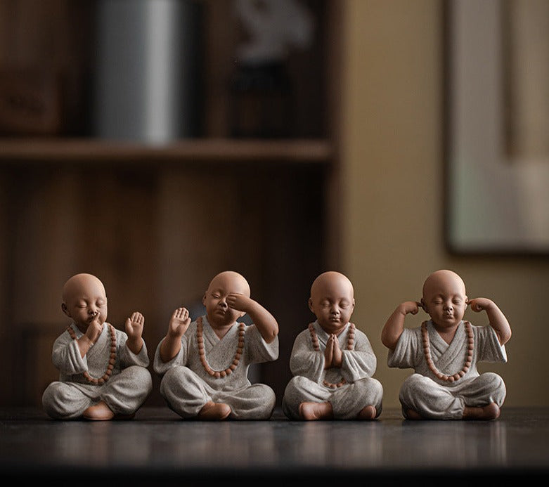 this is a mini pottery monk sculpture