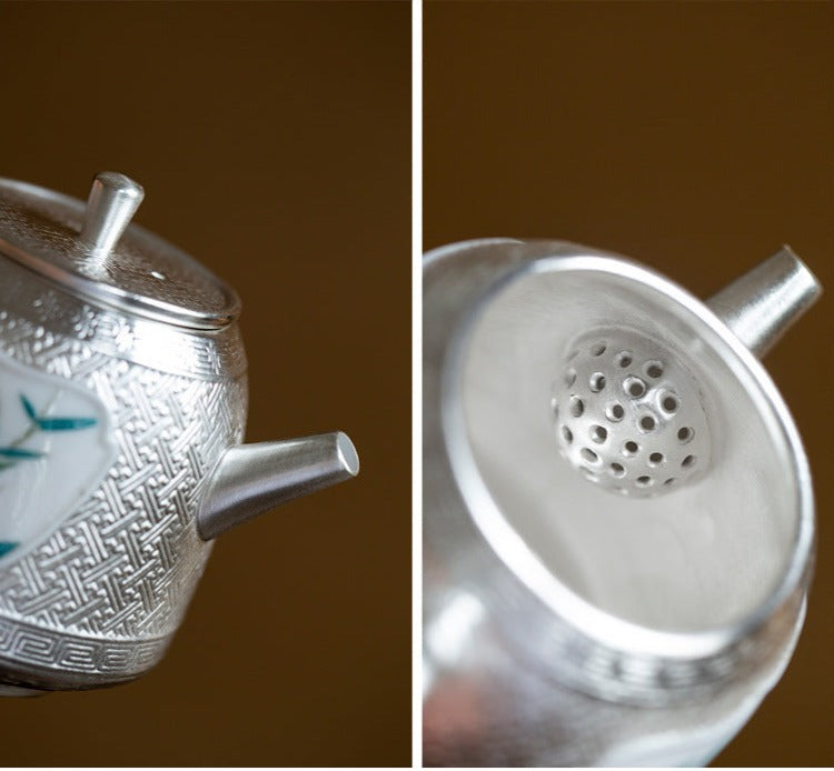 This is a gilted silver ceramic teapot