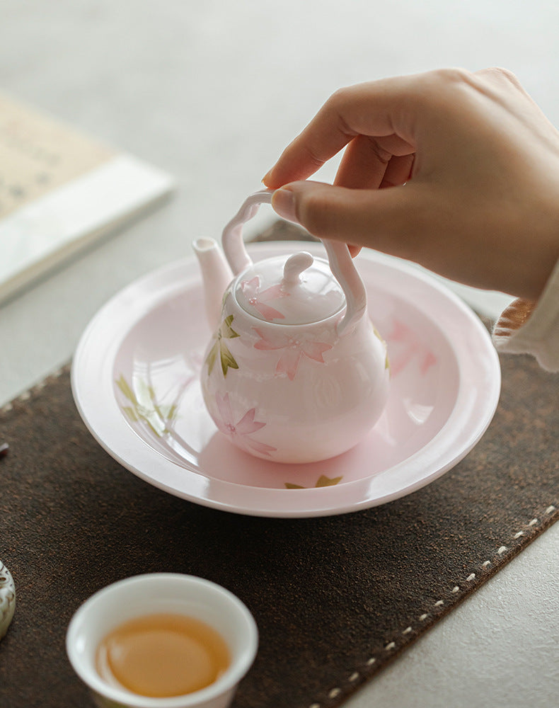 this is a pink ceramic teapot