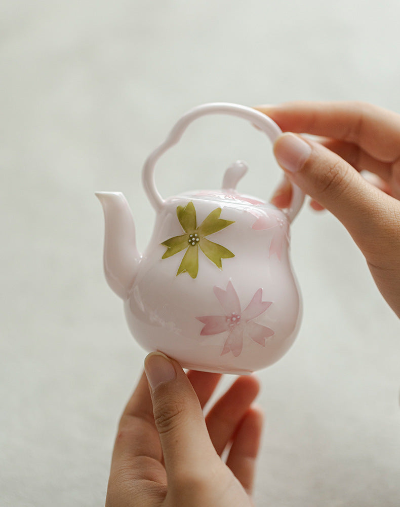 this is a pink ceramic teapot