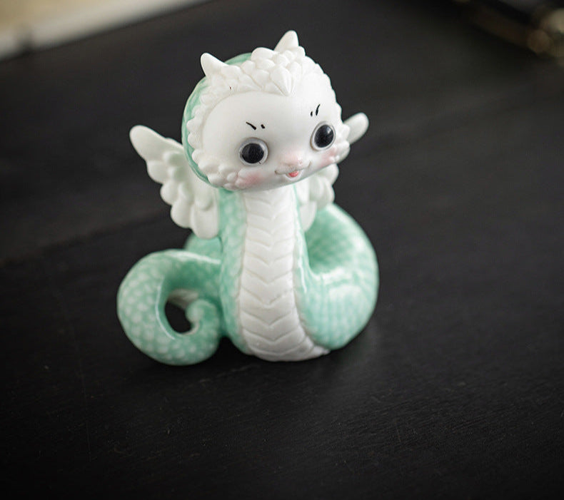 this is a white ceramic snake tea pet