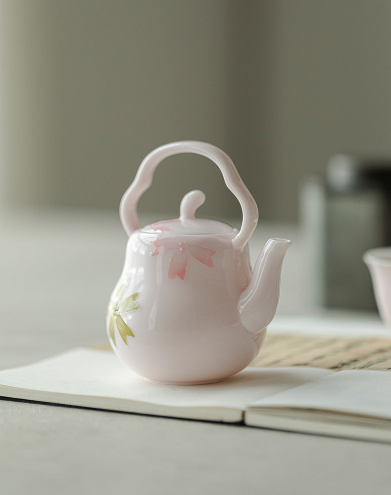 this is a pink ceramic teapot