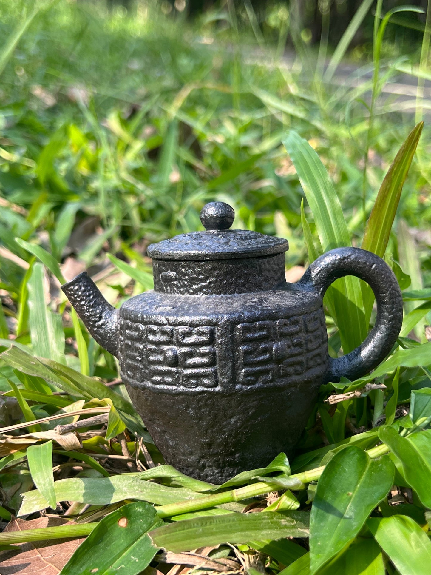 this is a pottery teapot. this is a purple clay teapot