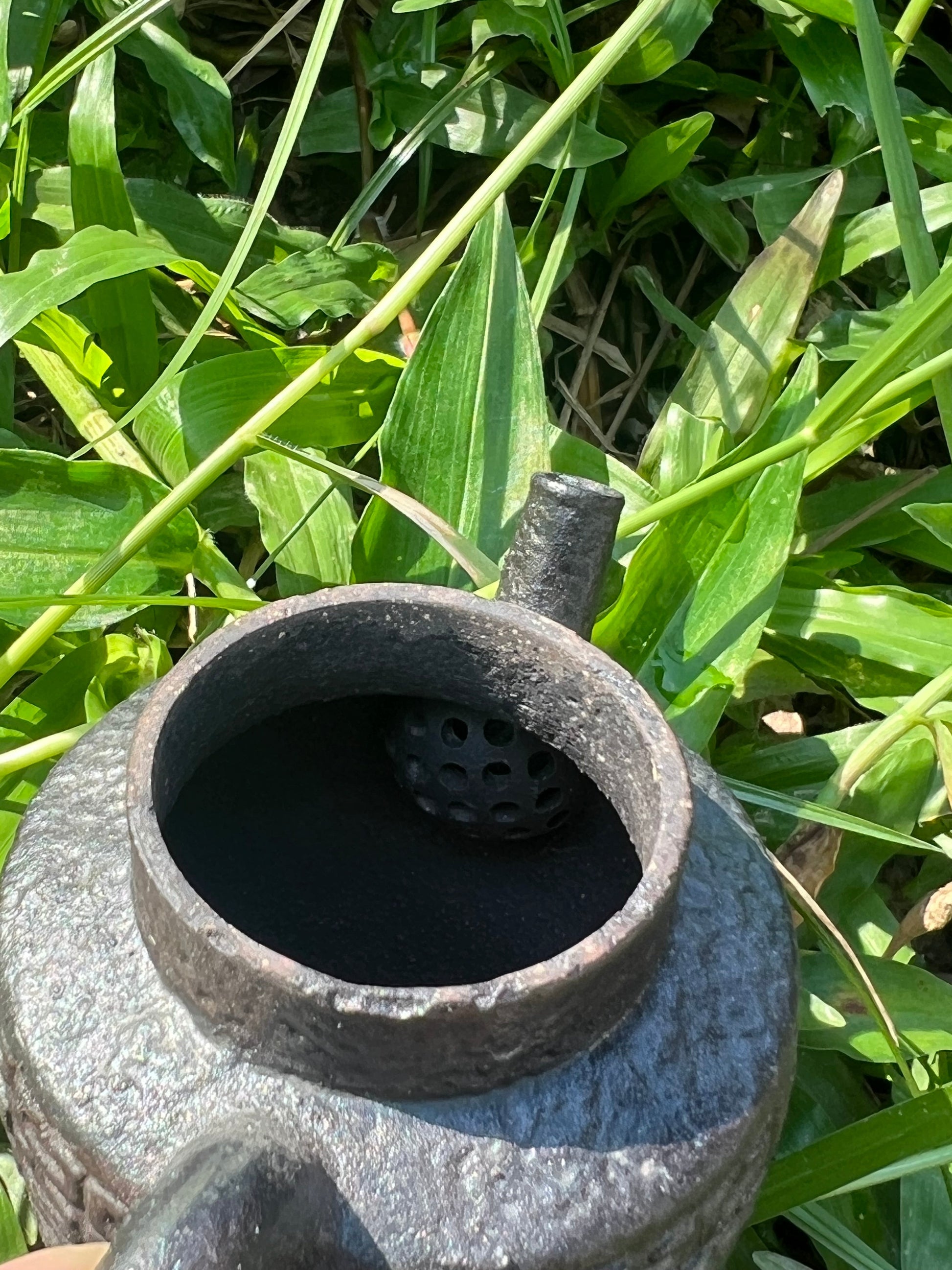 this is a pottery teapot. this is a purple clay teapot