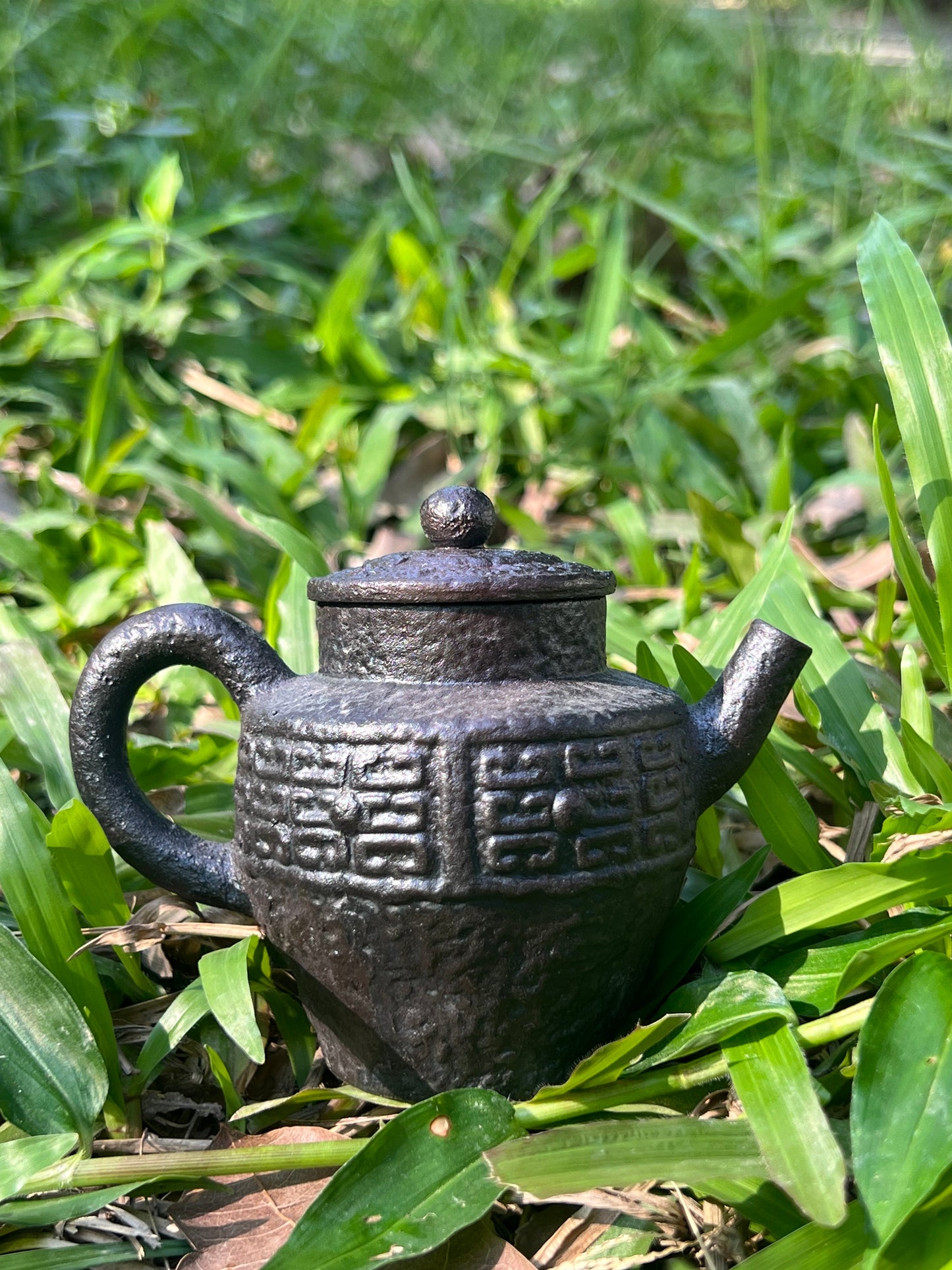 this is a pottery teapot. this is a purple clay teapot