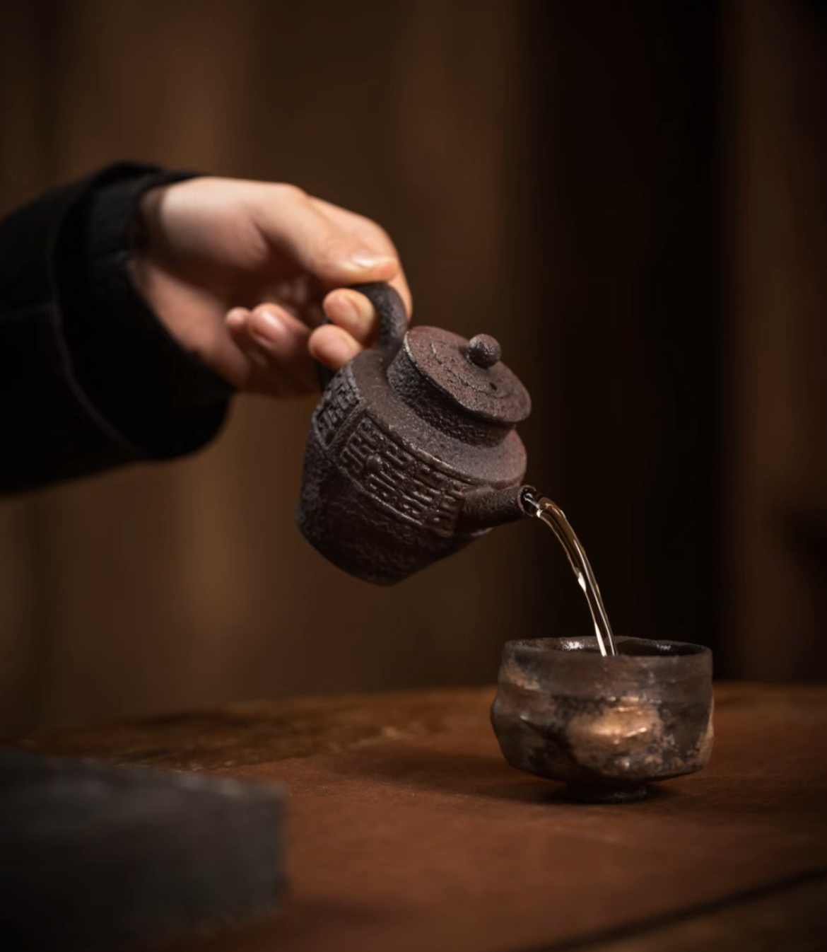 this is a pottery teapot. this is a purple clay teapot