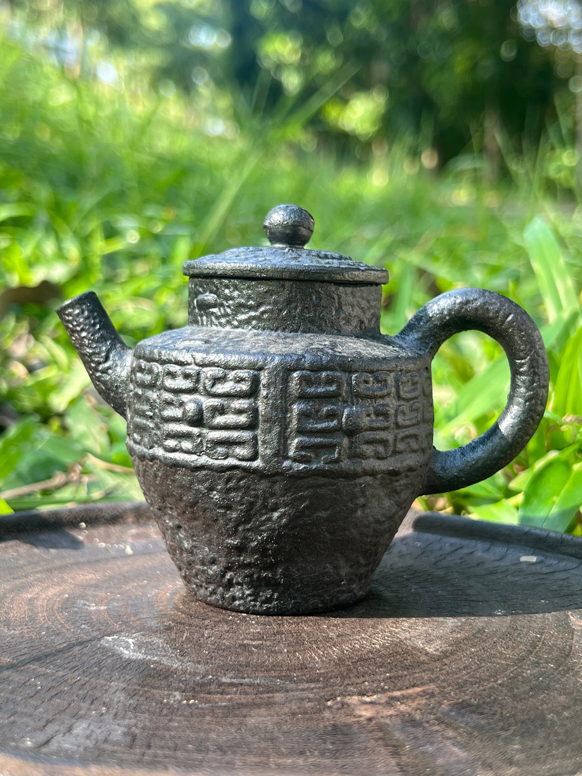 this is a pottery teapot. this is a purple clay teapot