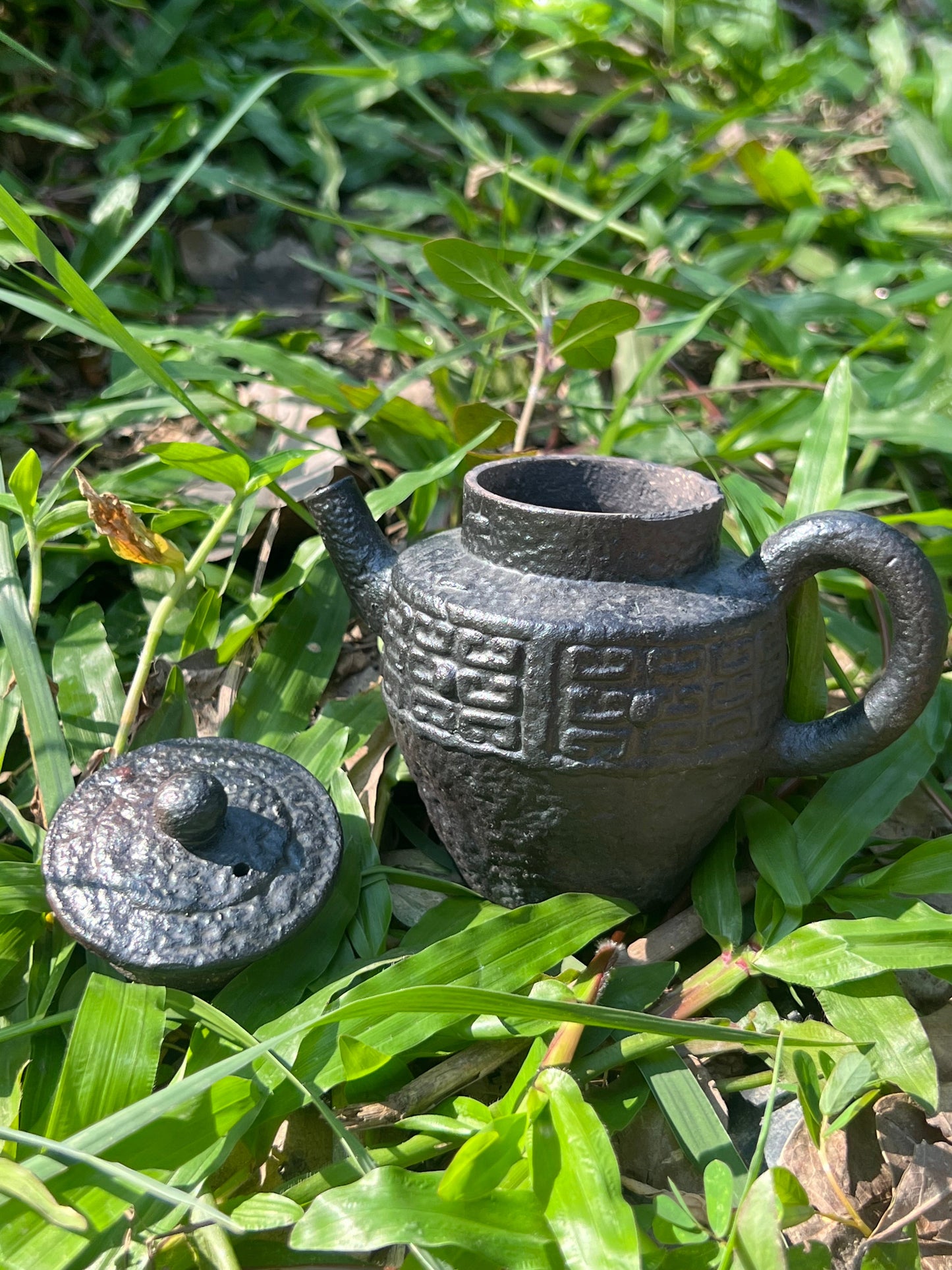 this is a pottery teapot. this is a purple clay teapot