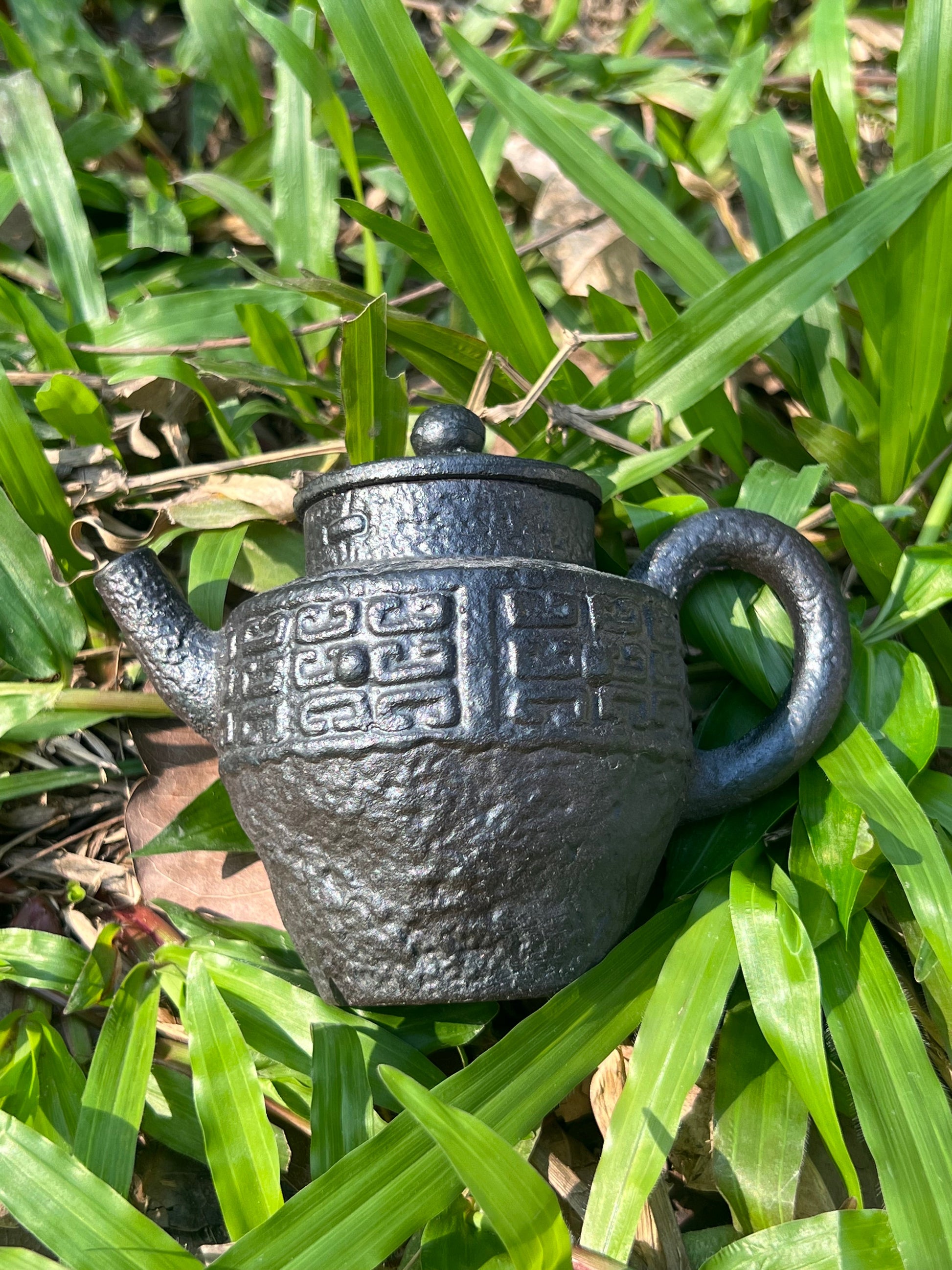 this is a pottery teapot. this is a purple clay teapot