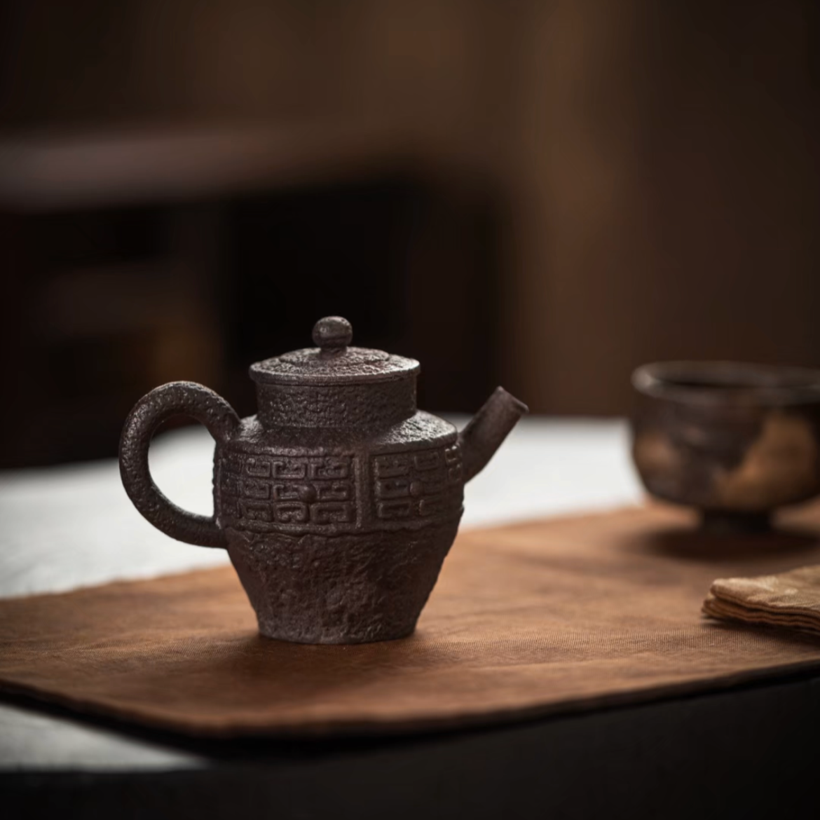 this is a pottery teapot. this is a purple clay teapot