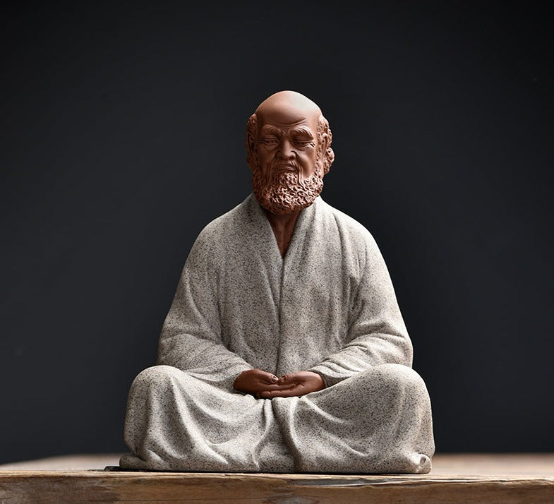 this is a pottery mini bodhidharma sculpture