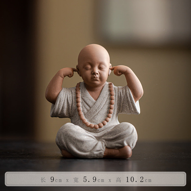 this is a mini pottery monk sculpture