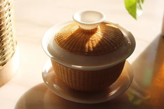 This is a ceramic teapot.this is bamboo woven teapot