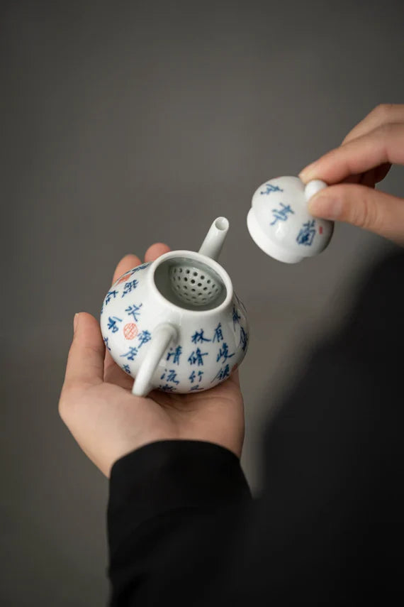 This is a white ceramic teapot