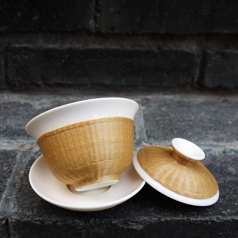 This is a ceramic teapot.this is bamboo woven teapot