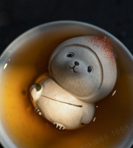 This is a Yixing purple clay peach panda teapet